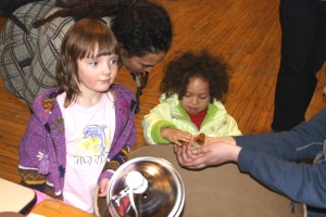 Young girls check out a baby chick during the Let's Grow Sitka garden education event on March 21, 2010, at ANB Hall in Sitka